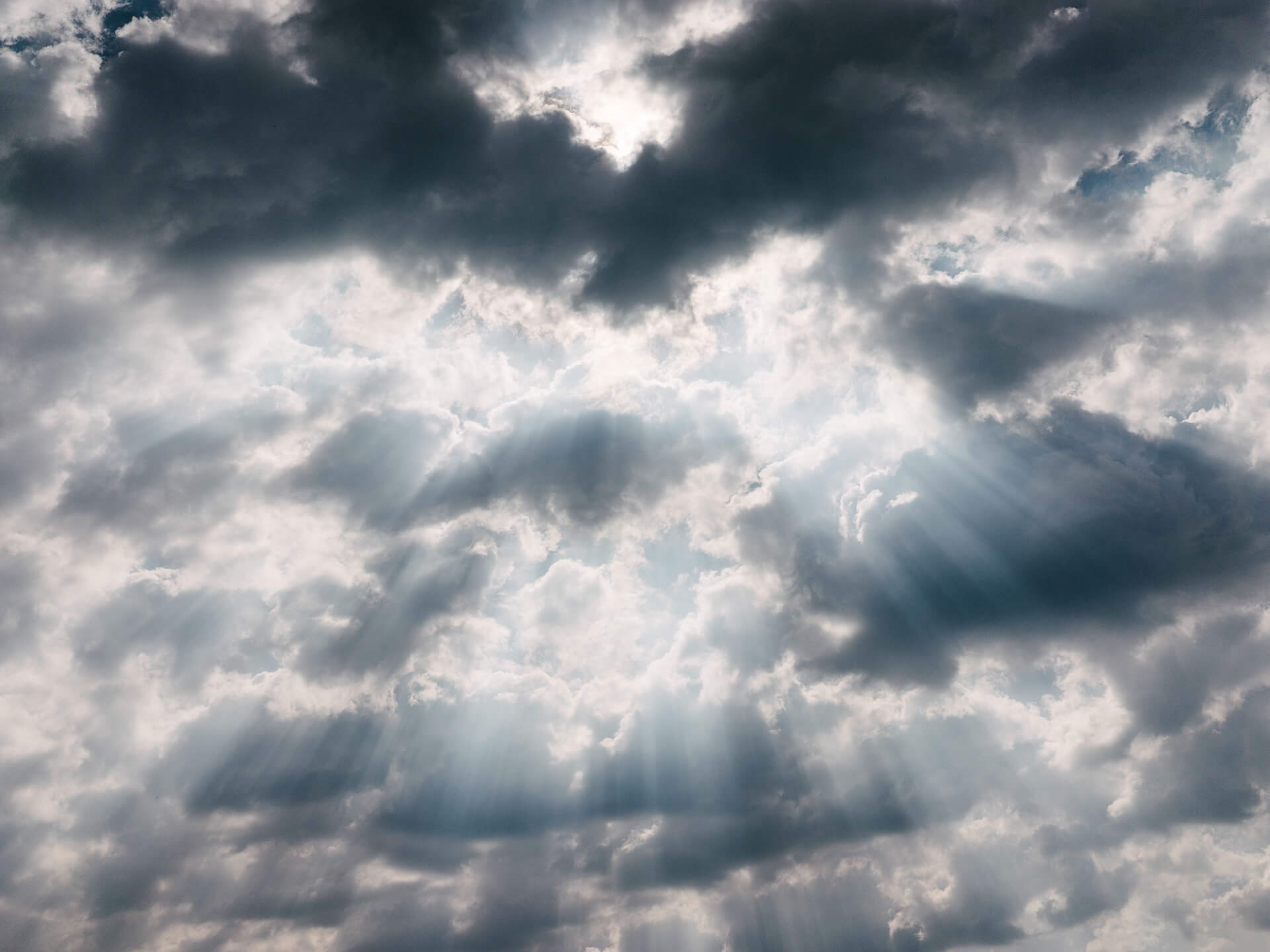 Sunbeams breaking through dark clouds