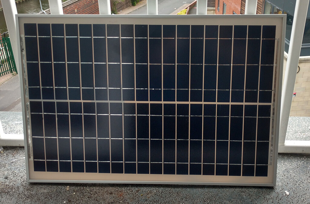 The new 20W solar panel propped against a window