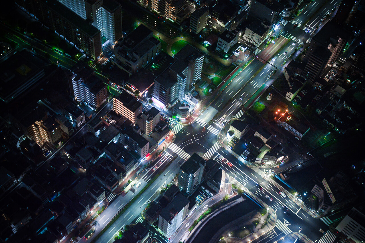 Aerial view of city streets lit up at night