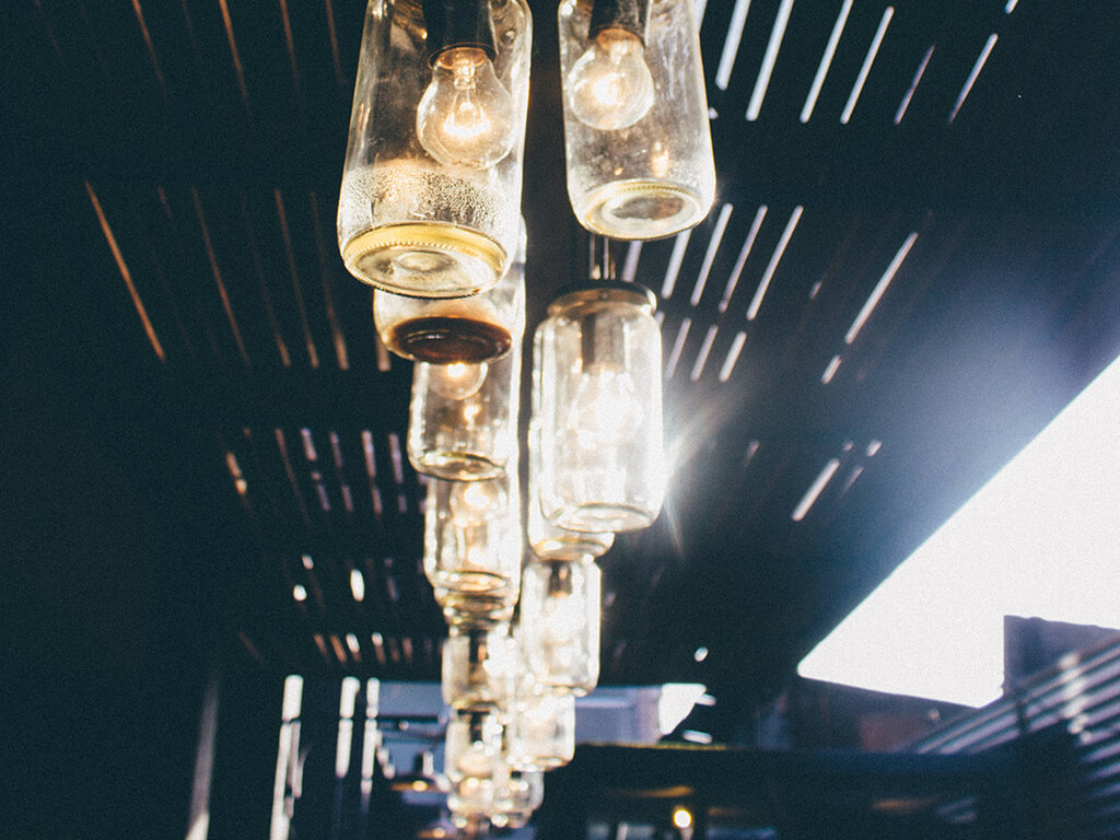 Pendant lights made from glass jars, hanging in a row
