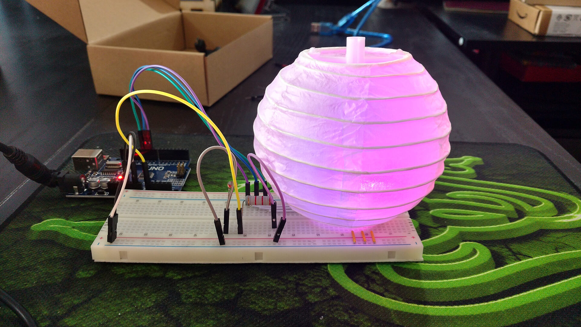 Creation Crate's first project: an Arduino and breadboard lighting a paper lantern pink