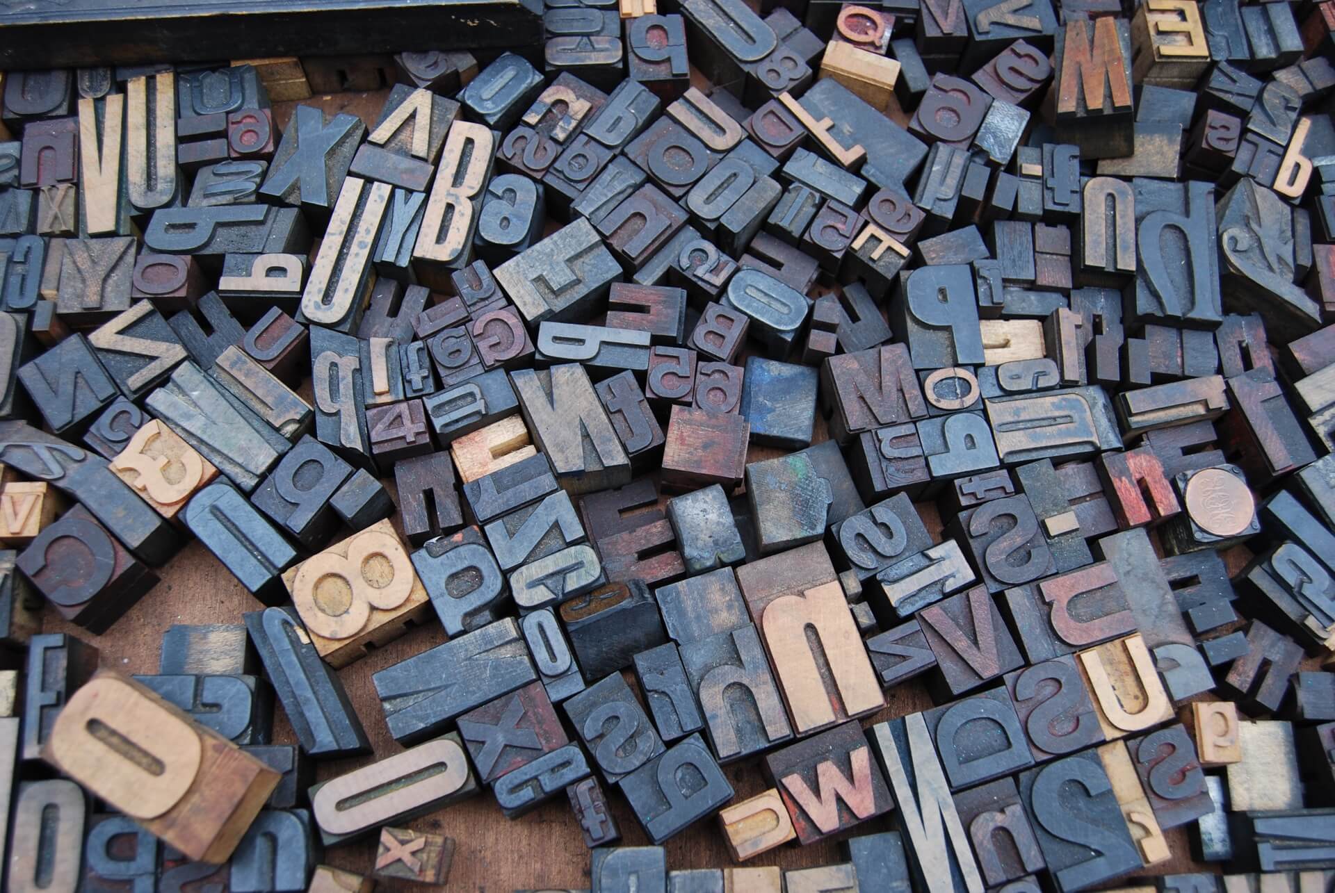 A jumble of wooden letterpress type blocks