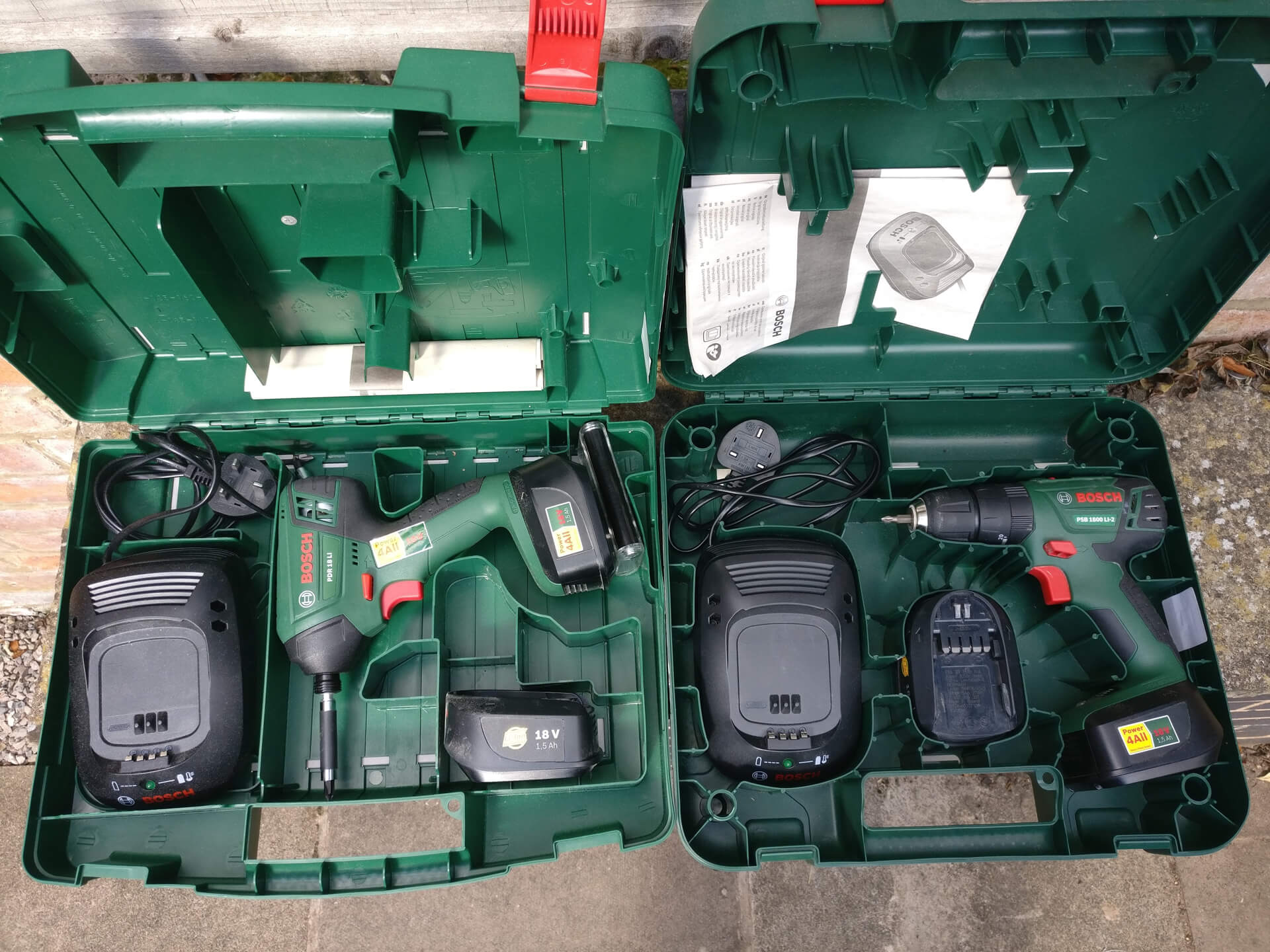 The Bosch impact driver and drill side by side in their cases