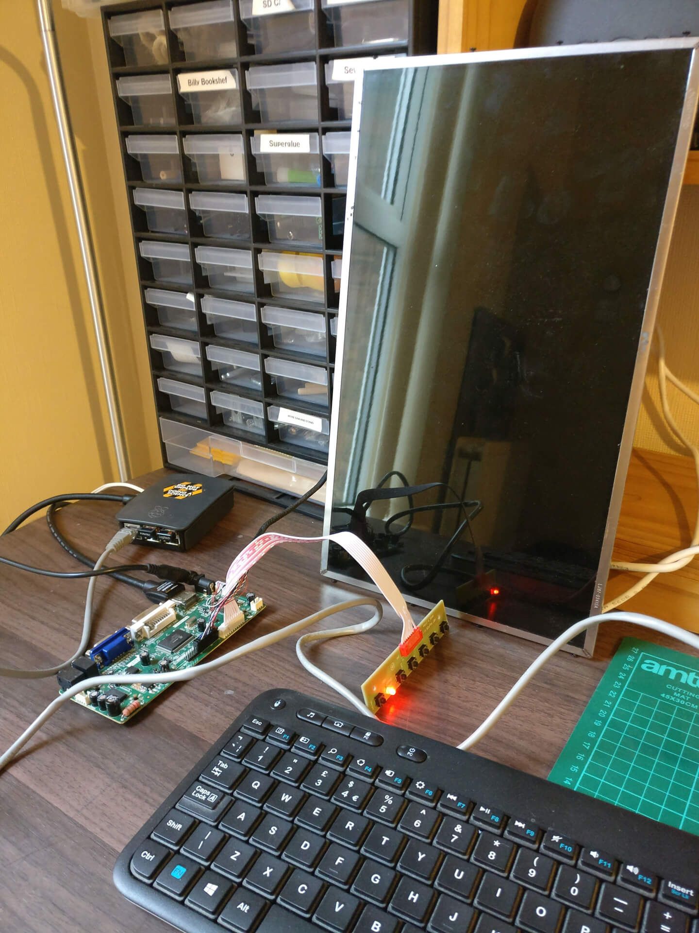 The prototype: an old laptop screen wired to a Raspberry Pi and driver board, with a keyboard in front