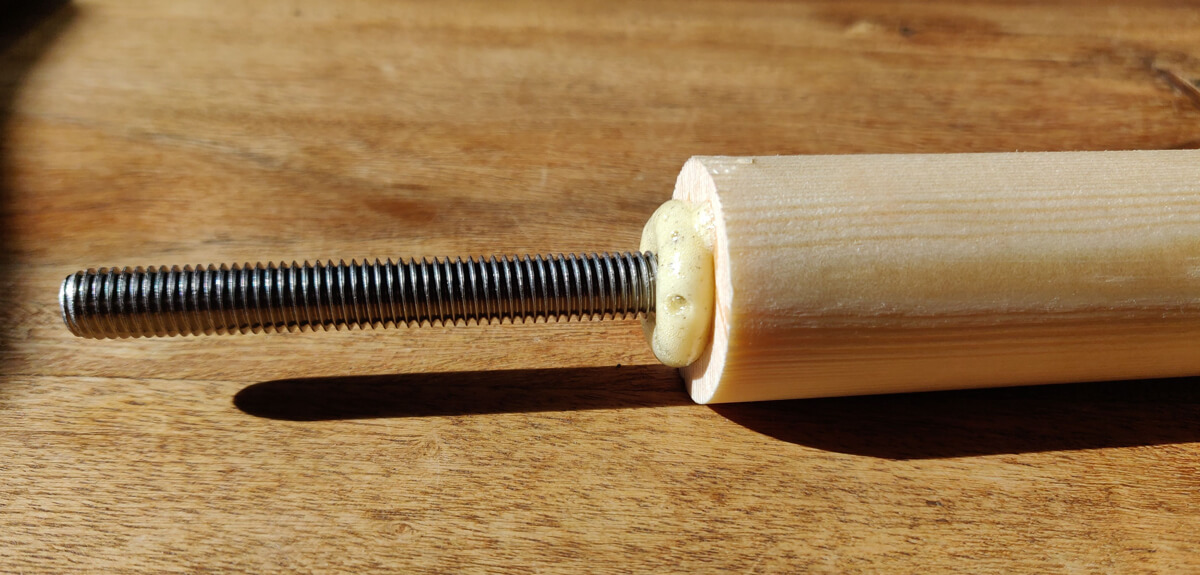 A bolt glued into the end of a dowel, with expanded glue foamed around it