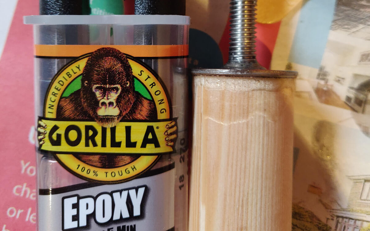 The bolt set into the dowel with epoxy, next to a tube of Gorilla Epoxy