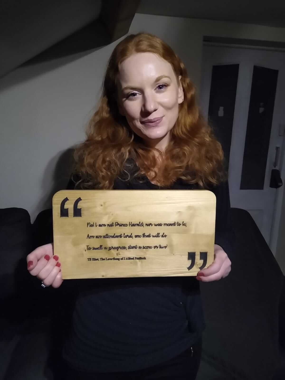 Becky holding the finished quote display in front of her, smiling