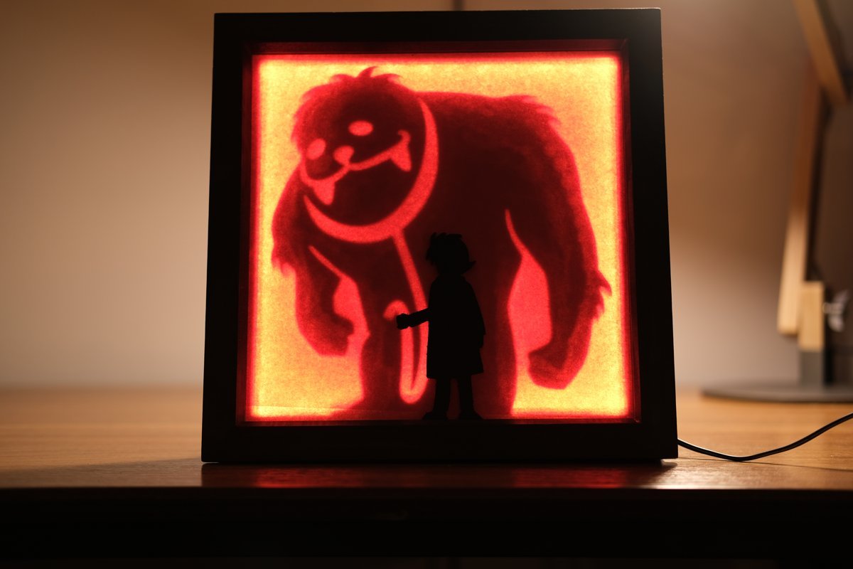 The same frame lit from behind, revealing a large furry monster silhouette looming over the girl